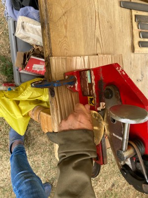 Cutting a piece of metal.