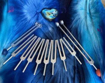 Tuning forks on a azure blanket.